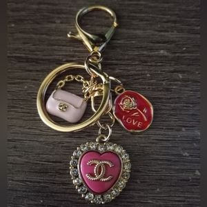 Authentic CHANEL pink rhinestone heart button on an unbranded keychain